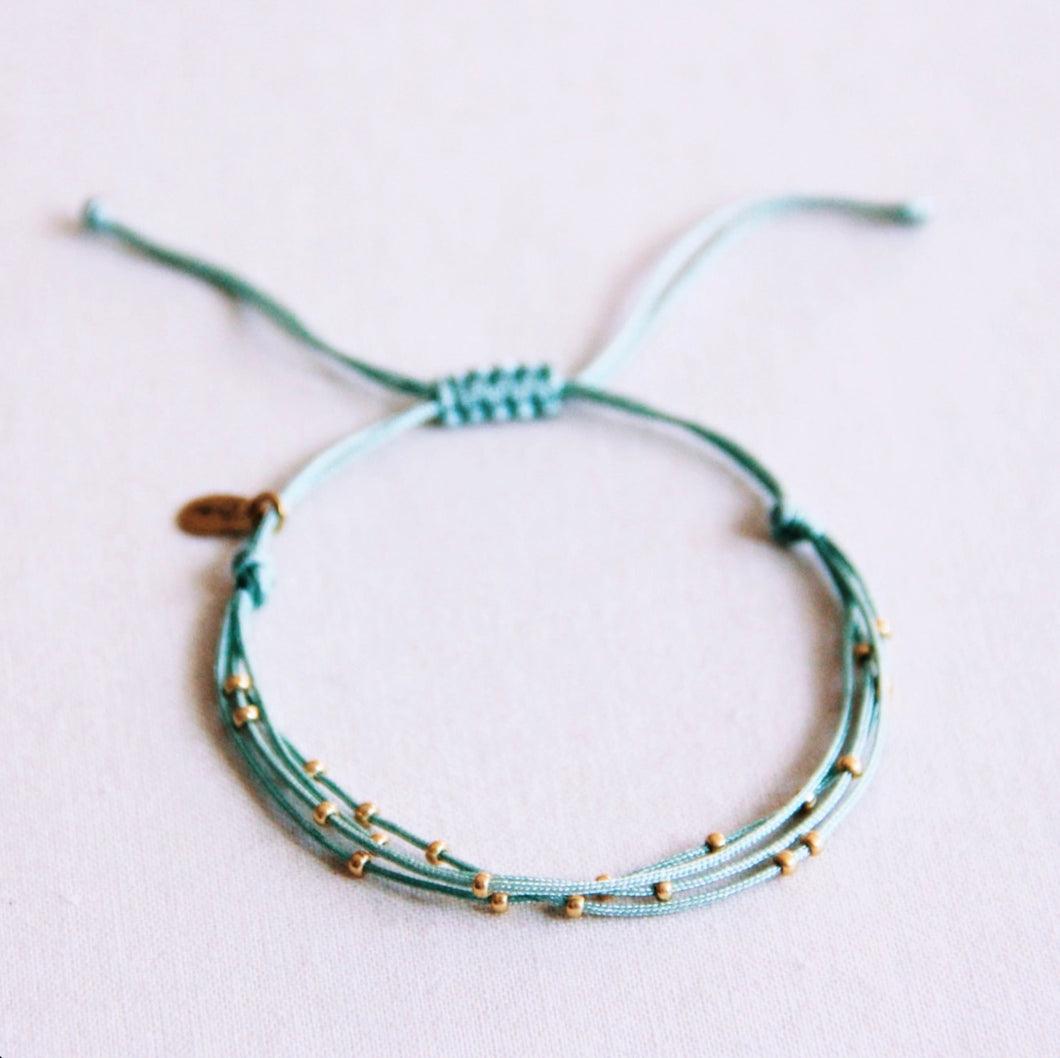 Quadruple satin bracelet with beads old green